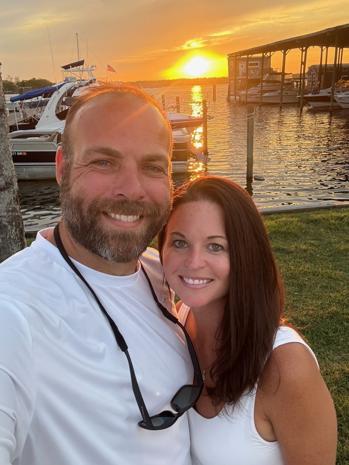 Tim Sherman and his wife at sunset beside the water