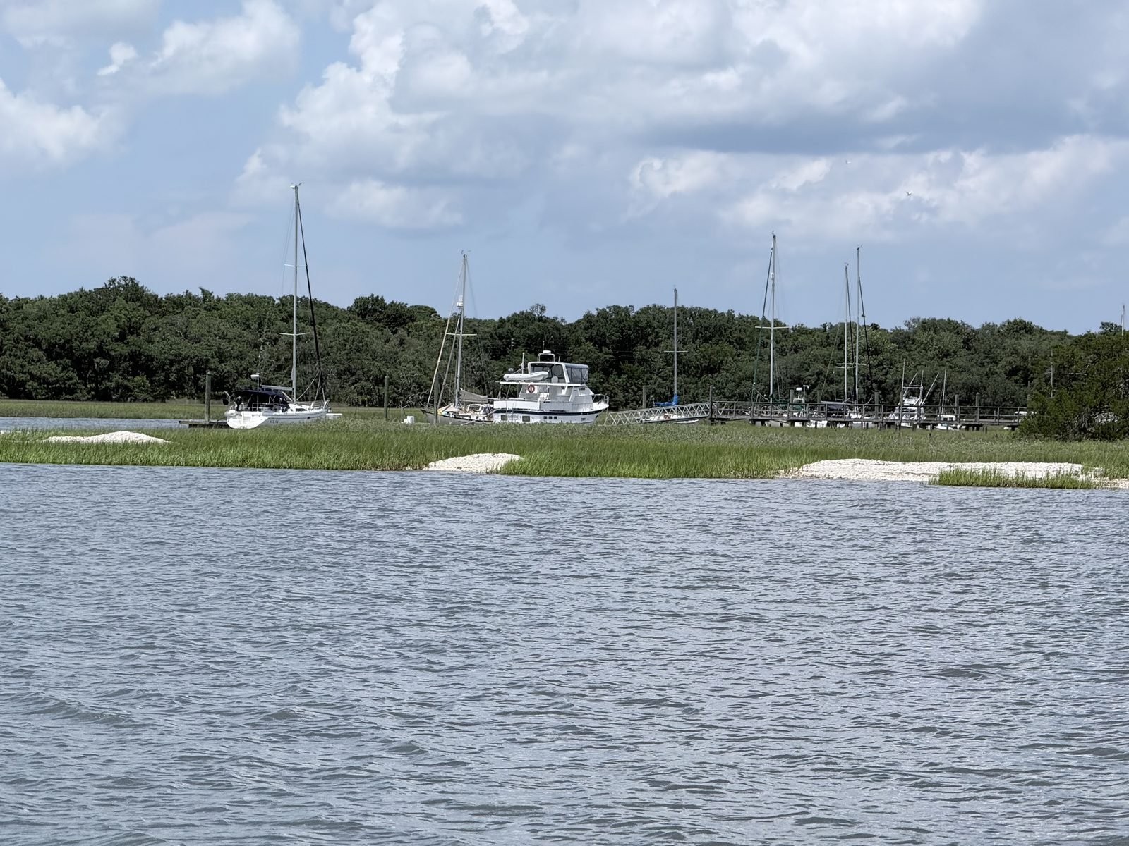 Sailboats at a dock beyond the salt marsh near Fernandina Beach, Florida
